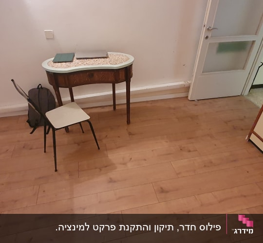 רצפת פרקט עץ בחדר עם שולחן וכיסא